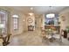 Open concept dining area with a glass-top table and chairs, flows into the living room at 1644 Linz Ct, Winter Haven, FL 33884