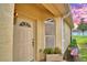 Inviting front entrance with a charming door and window, flanked by landscaping at 1644 Linz Ct, Winter Haven, FL 33884