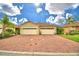 Front view of two-car garage home with brick driveway at 1644 Linz Ct, Winter Haven, FL 33884