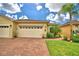 Front view of two-car garage home with brick driveway at 1644 Linz Ct, Winter Haven, FL 33884