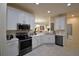 Modern kitchen with white cabinets, stainless steel appliances and an island at 1644 Linz Ct, Winter Haven, FL 33884
