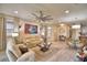 Spacious living room with beige sofa, large TV, and wood-look floors at 1644 Linz Ct, Winter Haven, FL 33884