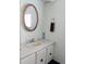 Clean bathroom with a vanity, mirror, and towel rack. Has a single sink and adequate storage at 175 Bonnie Dr, Auburndale, FL 33823