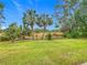 Landscaped backyard with lush tropical plants and palm trees at 18 Coventry Dr, Haines City, FL 33844