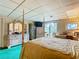 Main bedroom with a four-poster bed, dresser, and access to a balcony at 18 Coventry Dr, Haines City, FL 33844