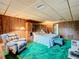 Bedroom with a king-size bed, recliner, and wood-paneled walls at 18 Coventry Dr, Haines City, FL 33844
