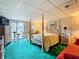 Main bedroom with four-poster bed, dresser, and sliding glass doors to patio at 18 Coventry Dr, Haines City, FL 33844