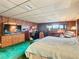 Bedroom with king-size bed, dresser, and wood-paneled walls at 18 Coventry Dr, Haines City, FL 33844