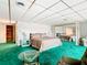 Spacious bedroom with mirrored closet and teal carpet at 18 Coventry Dr, Haines City, FL 33844