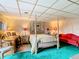 Spacious bedroom with a four-poster bed, desk, and red chaise lounge at 18 Coventry Dr, Haines City, FL 33844