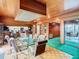 Dining room with glass table, wood-paneled walls, and access to patio at 18 Coventry Dr, Haines City, FL 33844