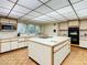 Kitchen features an island, ample cabinetry, and modern appliances at 18 Coventry Dr, Haines City, FL 33844
