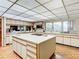 Large kitchen with island, white cabinets, and stainless steel appliances at 18 Coventry Dr, Haines City, FL 33844