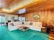 Relaxing living room with sectional sofa and wood paneled walls at 18 Coventry Dr, Haines City, FL 33844