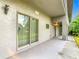 Small patio with sliding glass doors and exterior access at 18 Coventry Dr, Haines City, FL 33844