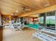 Bright sunroom with glass sliders opening to a view and seating for six at 18 Coventry Dr, Haines City, FL 33844