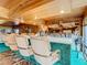 Home bar with seating and abundant liquor storage at 18 Coventry Dr, Haines City, FL 33844