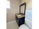 Bathroom features a granite vanity and hexagonal tile floor at 221 Lake Ned Rd, Winter Haven, FL 33884