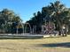 Community playground with swings and play structure at 222 Cattail Way, Lake Alfred, FL 33850