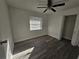 Spacious bedroom with wood-look floors and ceiling fan at 2349 Lisa St, Lake Wales, FL 33898