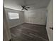 Bright bedroom with wood-look floors and ceiling fan at 2349 Lisa St, Lake Wales, FL 33898