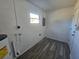 Laundry area with vinyl flooring and new water heater at 2349 Lisa St, Lake Wales, FL 33898
