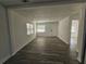Bright living room with wood-look floors and access to other rooms at 2349 Lisa St, Lake Wales, FL 33898