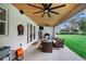 Spacious covered patio with ceiling fan and outdoor seating at 2997 Sequoyah Dr, Haines City, FL 33844