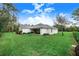 Spacious backyard with lush green grass and a covered patio at 2997 Sequoyah Dr, Haines City, FL 33844
