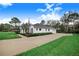 White home with a gray roof, landscaping and driveway at 2997 Sequoyah Dr, Haines City, FL 33844