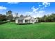 White house with black shutters and lush lawn at 2997 Sequoyah Dr, Haines City, FL 33844