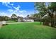 House with a manicured lawn and a long driveway at 2997 Sequoyah Dr, Haines City, FL 33844