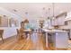 Modern kitchen with island, white cabinets and wood floors at 2997 Sequoyah Dr, Haines City, FL 33844