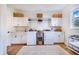 Bright laundry room with ample cabinet space and a utility sink at 2997 Sequoyah Dr, Haines City, FL 33844