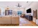 Spacious living room featuring a sectional sofa and large TV at 2997 Sequoyah Dr, Haines City, FL 33844