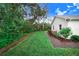 Side yard features lush landscaping and a pathway at 2997 Sequoyah Dr, Haines City, FL 33844