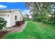 Landscaped side yard with brick pavers and a wooden fence at 2997 Sequoyah Dr, Haines City, FL 33844