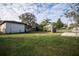 Large backyard with grassy area and partial fence at 302 E Palm St, Davenport, FL 33837