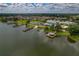 Aerial view of community clubhouse, pool, tennis courts, and lake access at 3309 Raleigh Dr, Winter Haven, FL 33884