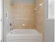 Clean bathroom with a bathtub and neutral tile at 3309 Raleigh Dr, Winter Haven, FL 33884