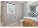 Bathroom with light wood cabinets and mosaic backsplash at 3309 Raleigh Dr, Winter Haven, FL 33884