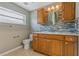 Updated bathroom with wood cabinets and mosaic tile at 3309 Raleigh Dr, Winter Haven, FL 33884