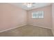 Light pink bedroom with carpet, ceiling fan, and window at 3309 Raleigh Dr, Winter Haven, FL 33884