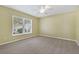 Bright bedroom with neutral walls, carpet flooring, and a ceiling fan at 3309 Raleigh Dr, Winter Haven, FL 33884