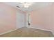 Bedroom with double doors leading to bathroom and ceiling fan at 3309 Raleigh Dr, Winter Haven, FL 33884