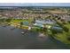 Aerial view of community with lake, clubhouse, and homes at 3309 Raleigh Dr, Winter Haven, FL 33884