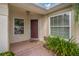 Inviting front entry with tiled flooring and a dark brown door at 3309 Raleigh Dr, Winter Haven, FL 33884