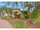 Landscaped front yard with lush tropical plants and brick pavers at 3309 Raleigh Dr, Winter Haven, FL 33884