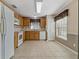 Kitchen with light wood cabinets, white appliances, and tile flooring at 3309 Raleigh Dr, Winter Haven, FL 33884