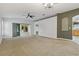 Spacious living room with carpet flooring, neutral walls, and sliding glass doors leading to the outdoors at 3309 Raleigh Dr, Winter Haven, FL 33884